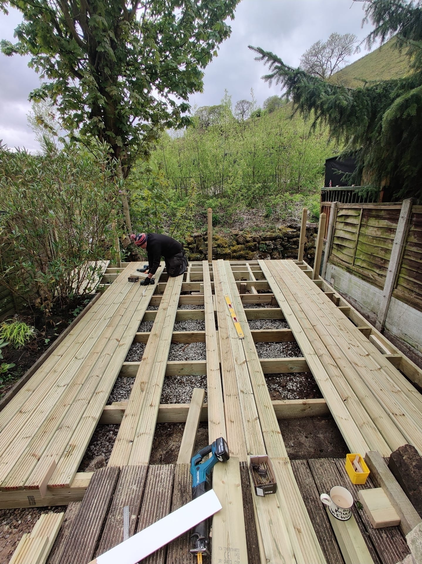 Gary laying decking boards on a new timber deck frame
